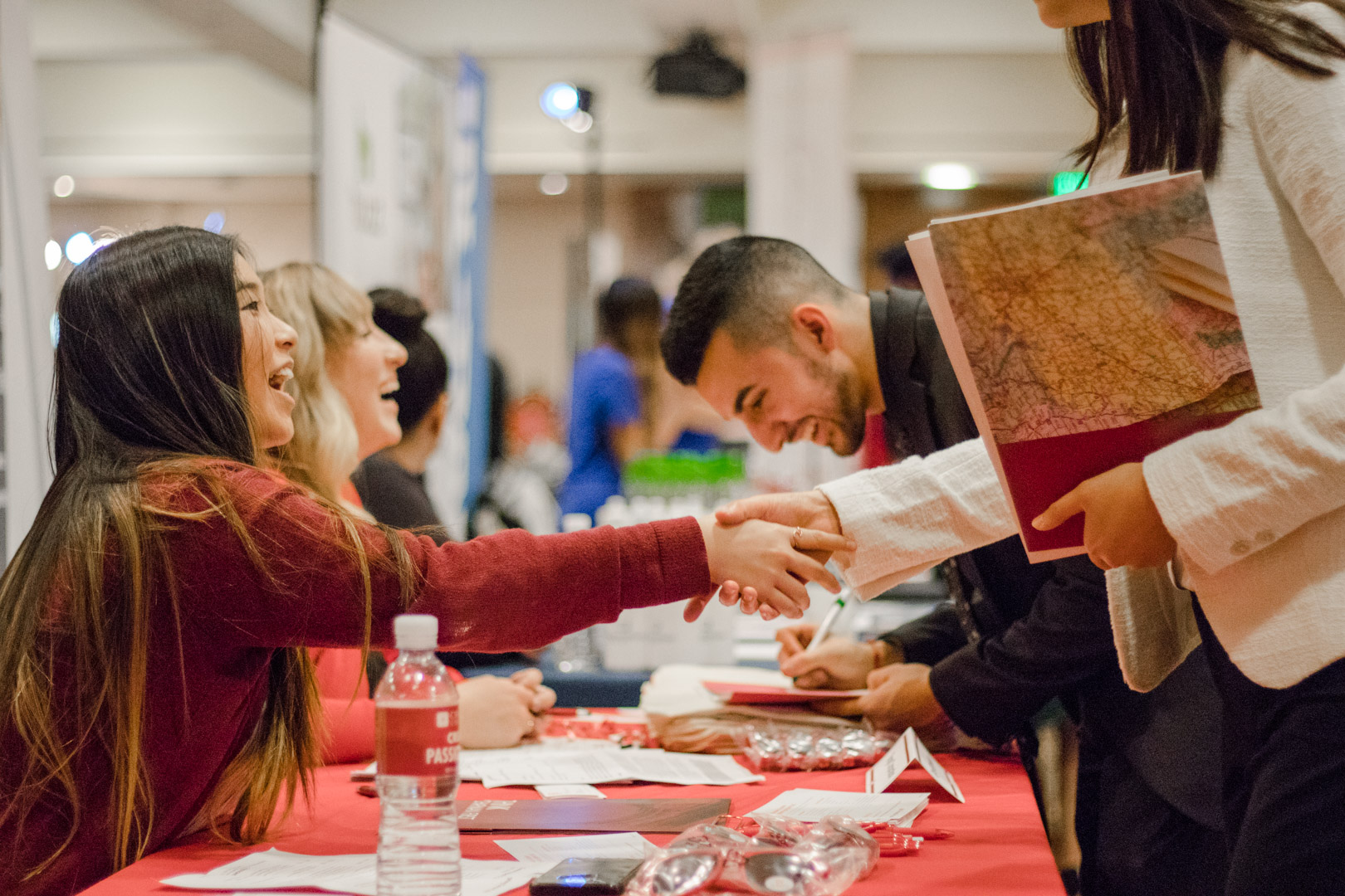 Students shake the hands of potential employers at the career fair.