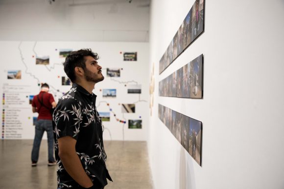 Man looks at artwork.