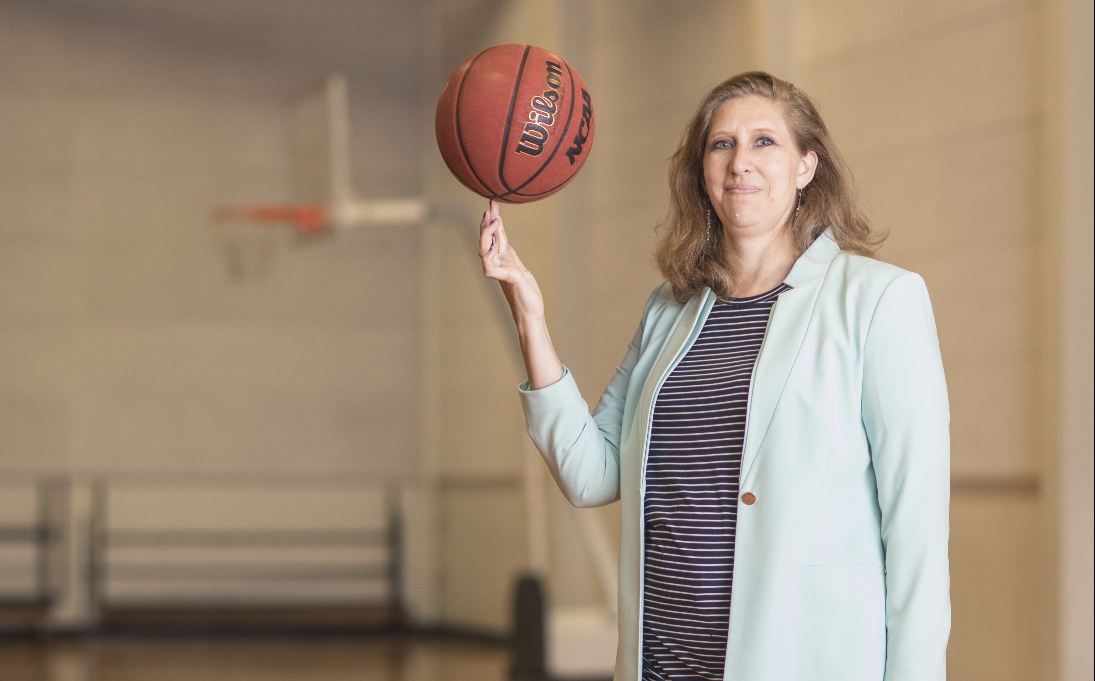 April Abeyta on basketball court with ball