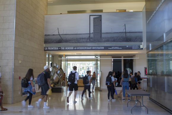 Students hustle through Beckman Hall.