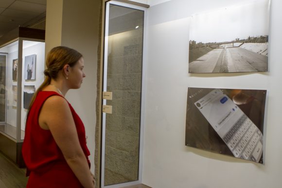 A student pauses to look at art.