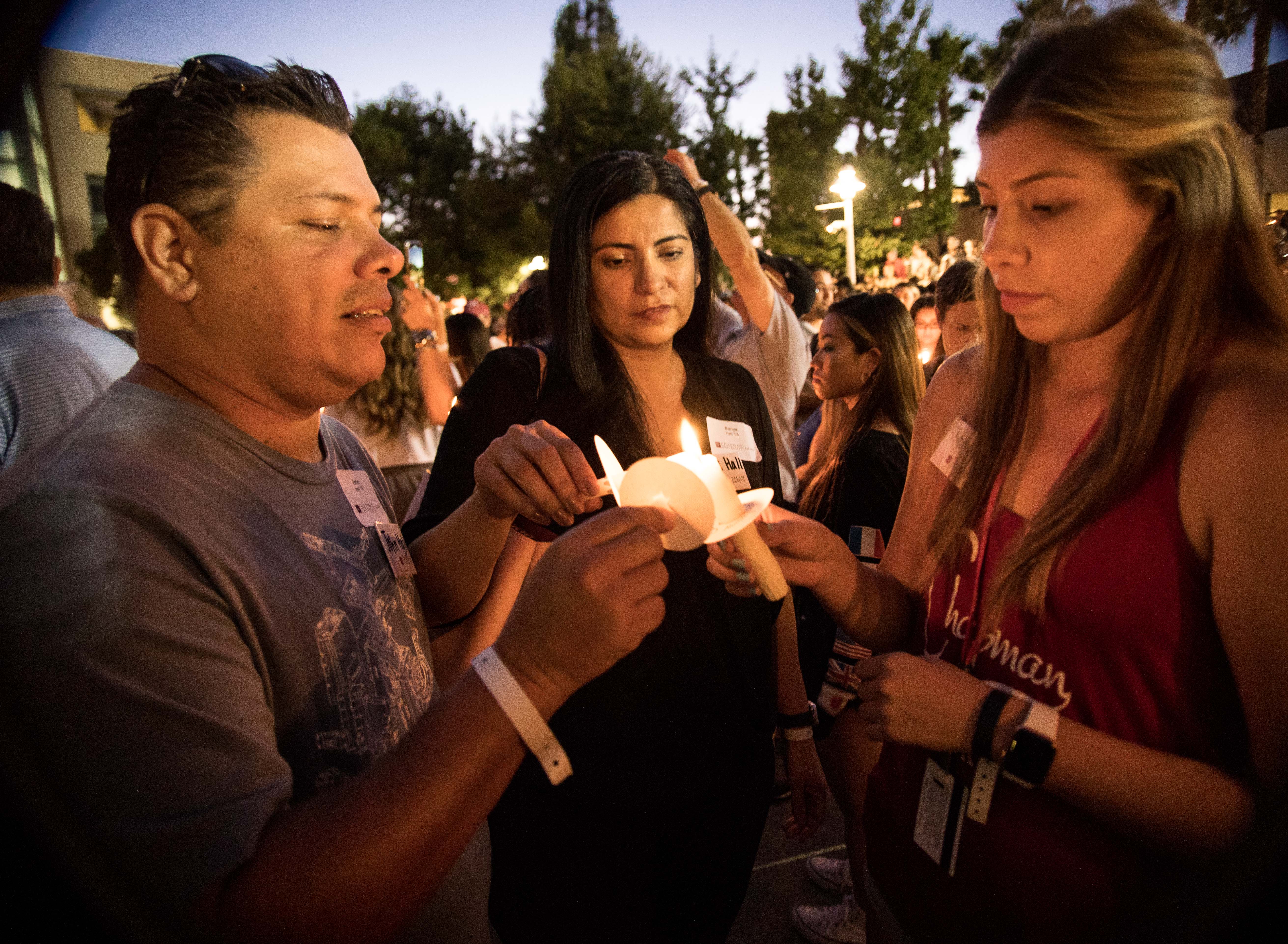 Alumni share wisdom as they light the candles of new students.
