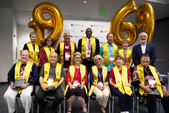 Group shot of the class of 1969 in stoles with balloons