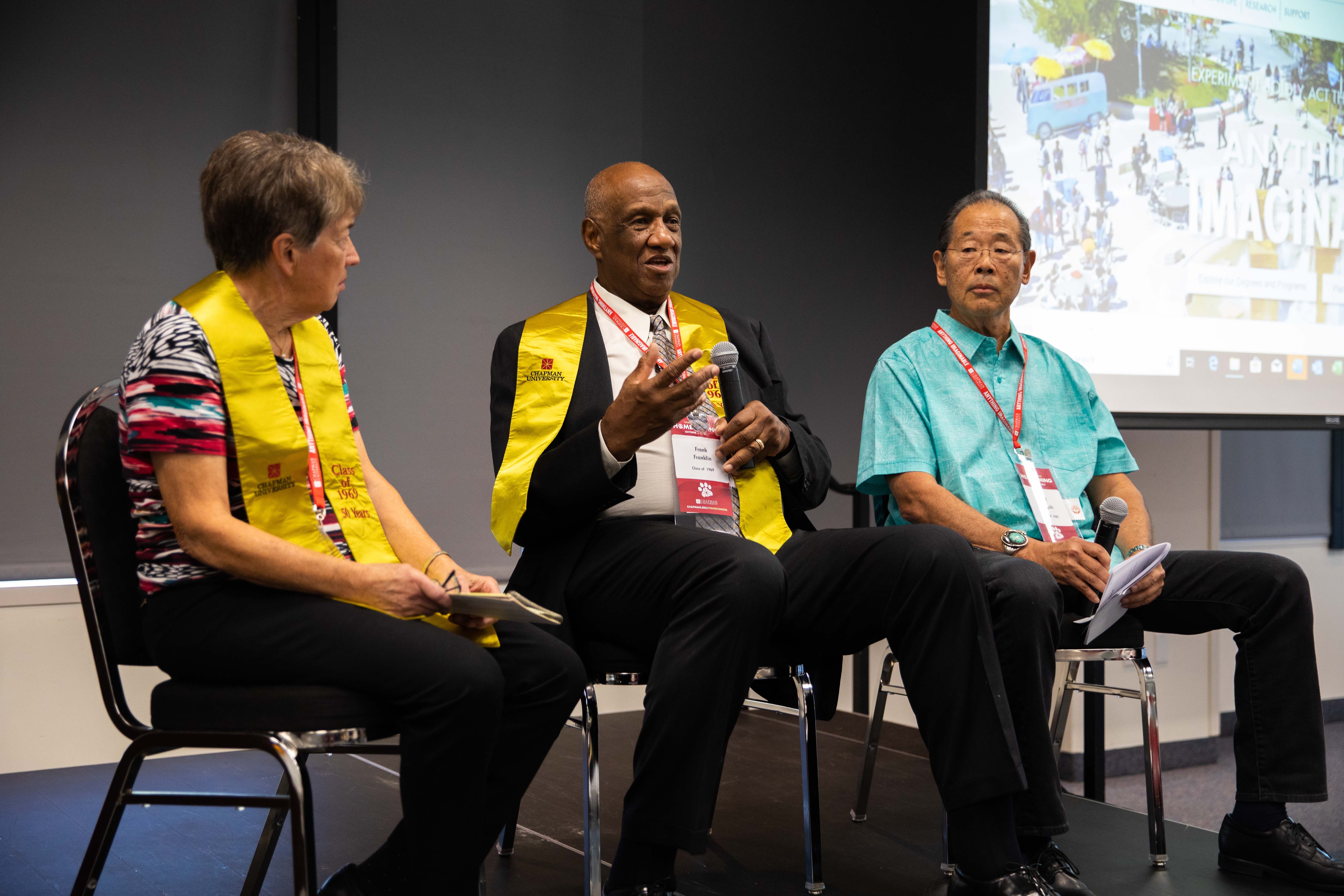 Karen Wilkinson, Frank Franklin, Cliff Ishigaka seated on stage