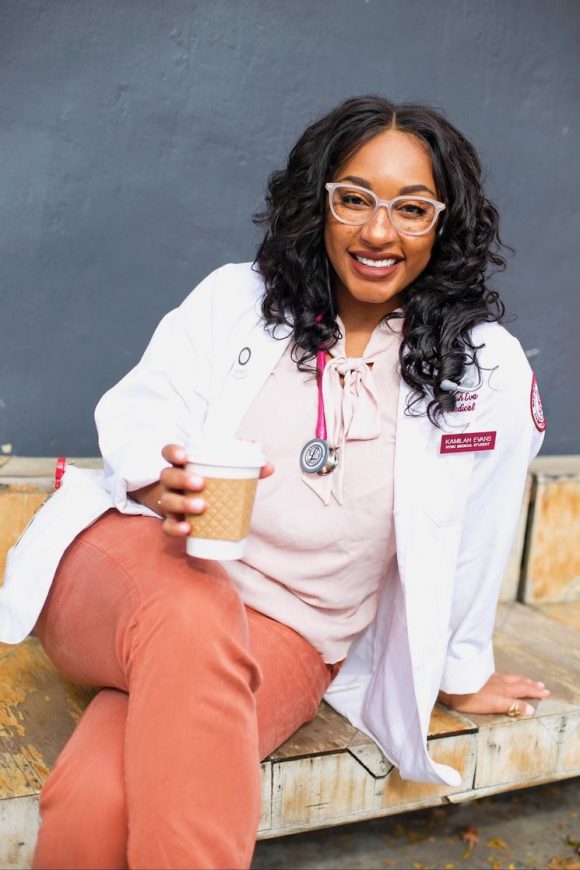 Kamilah poses with her white coat.