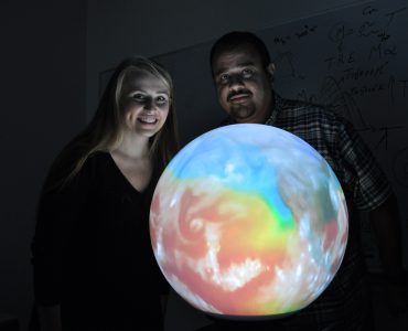 Krista and Hesham with globe