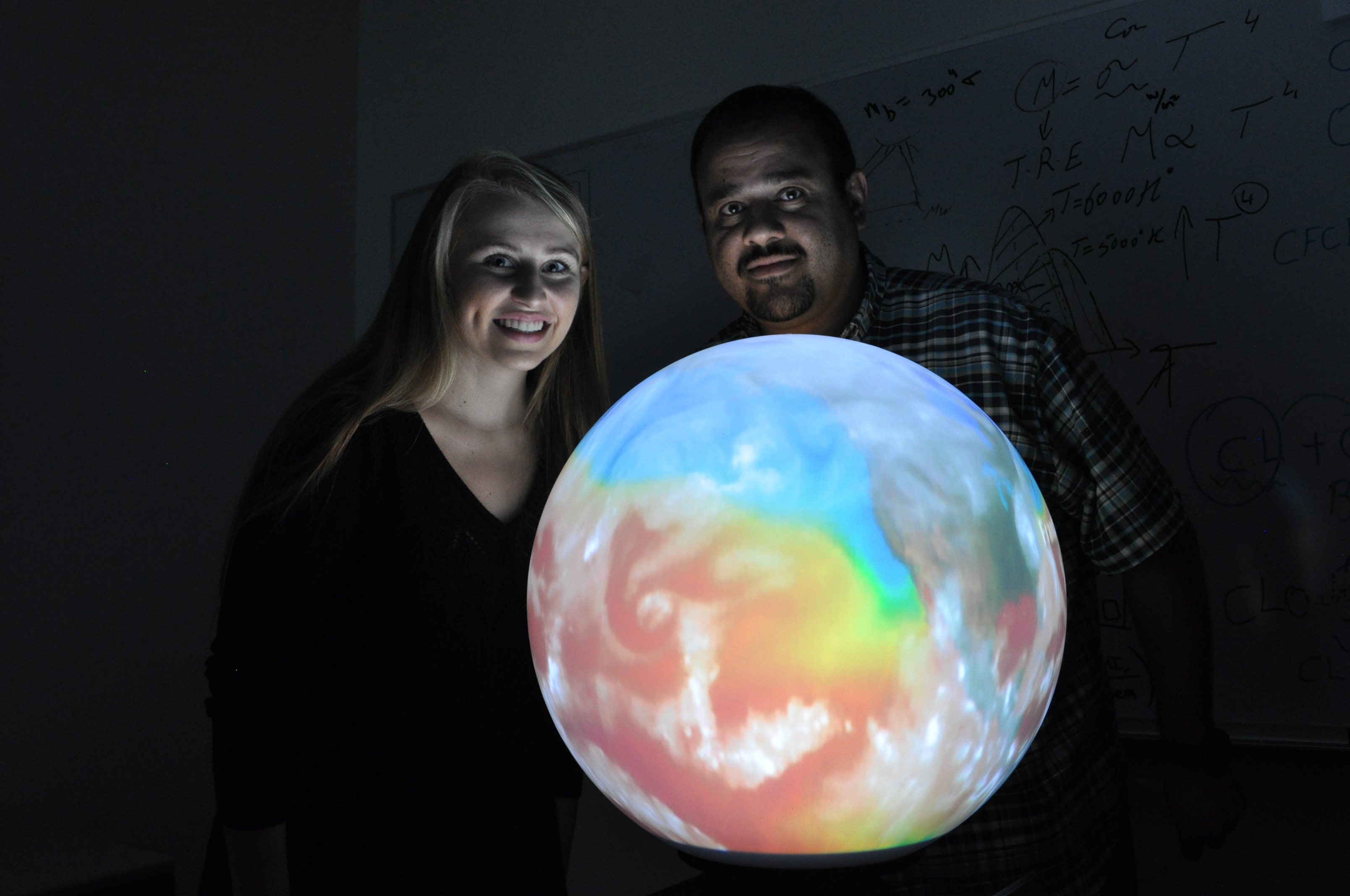 Krista and Hesham with globe