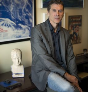 Professor Chris Bader at desk