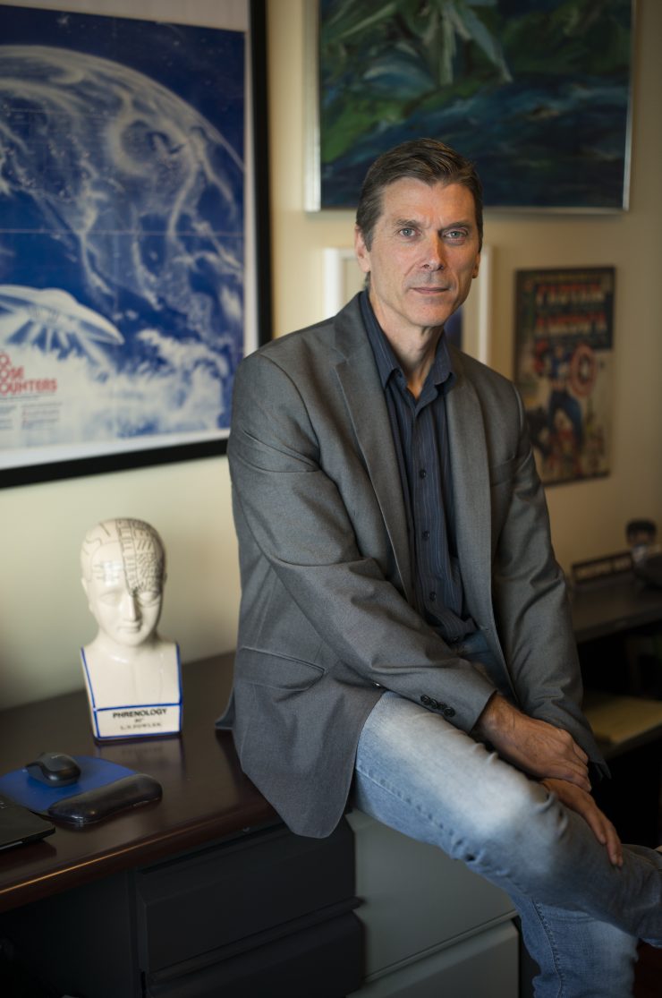 Professor Chris Bader at desk