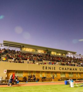 Twilight at Ernie Chapman Stadium with filled stands