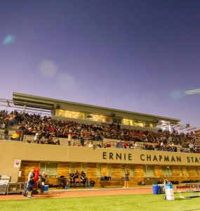 Twilight at Ernie Chapman Stadium with filled stands