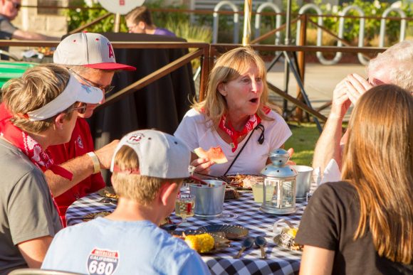 Group of adults enjoying a meal at a picnic