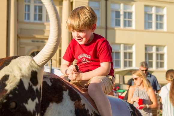 Boy in Chapman t-shirt on mechanical bull