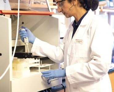 Kamaljit Kaur looks through a microscope