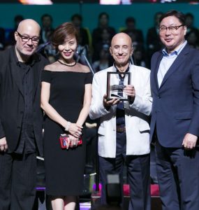 From left, Susan Yang and Menas Kafatos accept an award.