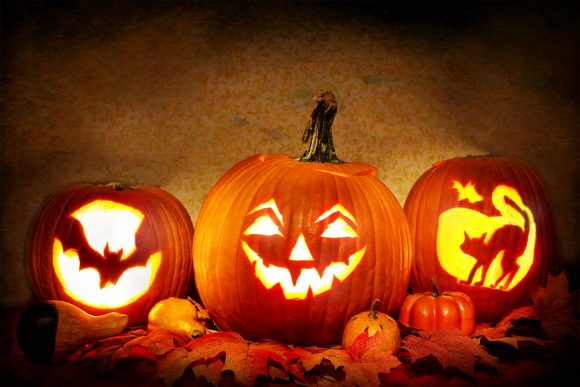 Jack-O-Lanterns cast glowing grins.