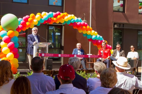 Daniele Struppa at the podium in front of the K Residence Hall