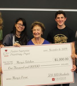five people with giant check