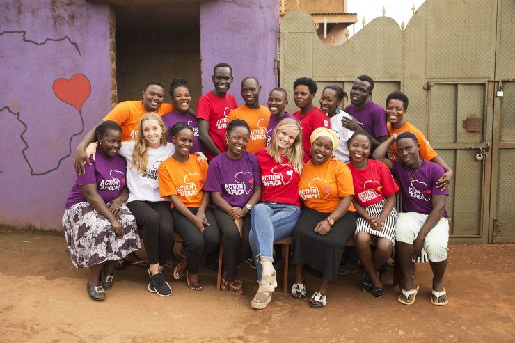 staff members in multicolored Action in Africa t-shirts