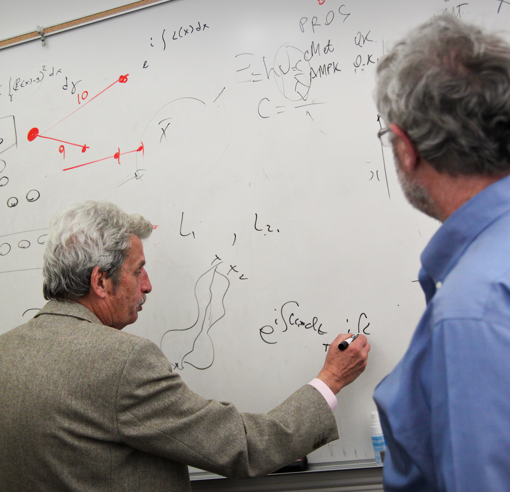 aharonov and founder
            and co-director of the Institute for
            Quantum Studies at Chapman sitting at table