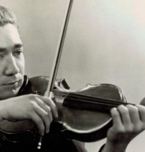 Young Henri Temianka playing the violin.