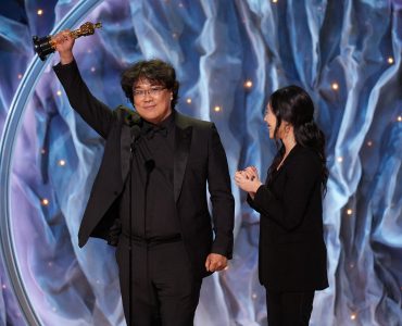 Bong Joon-ho holds up Oscar