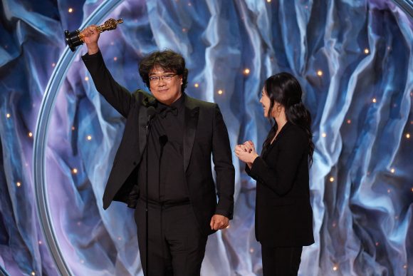 Bong Joon-ho holds up Oscar