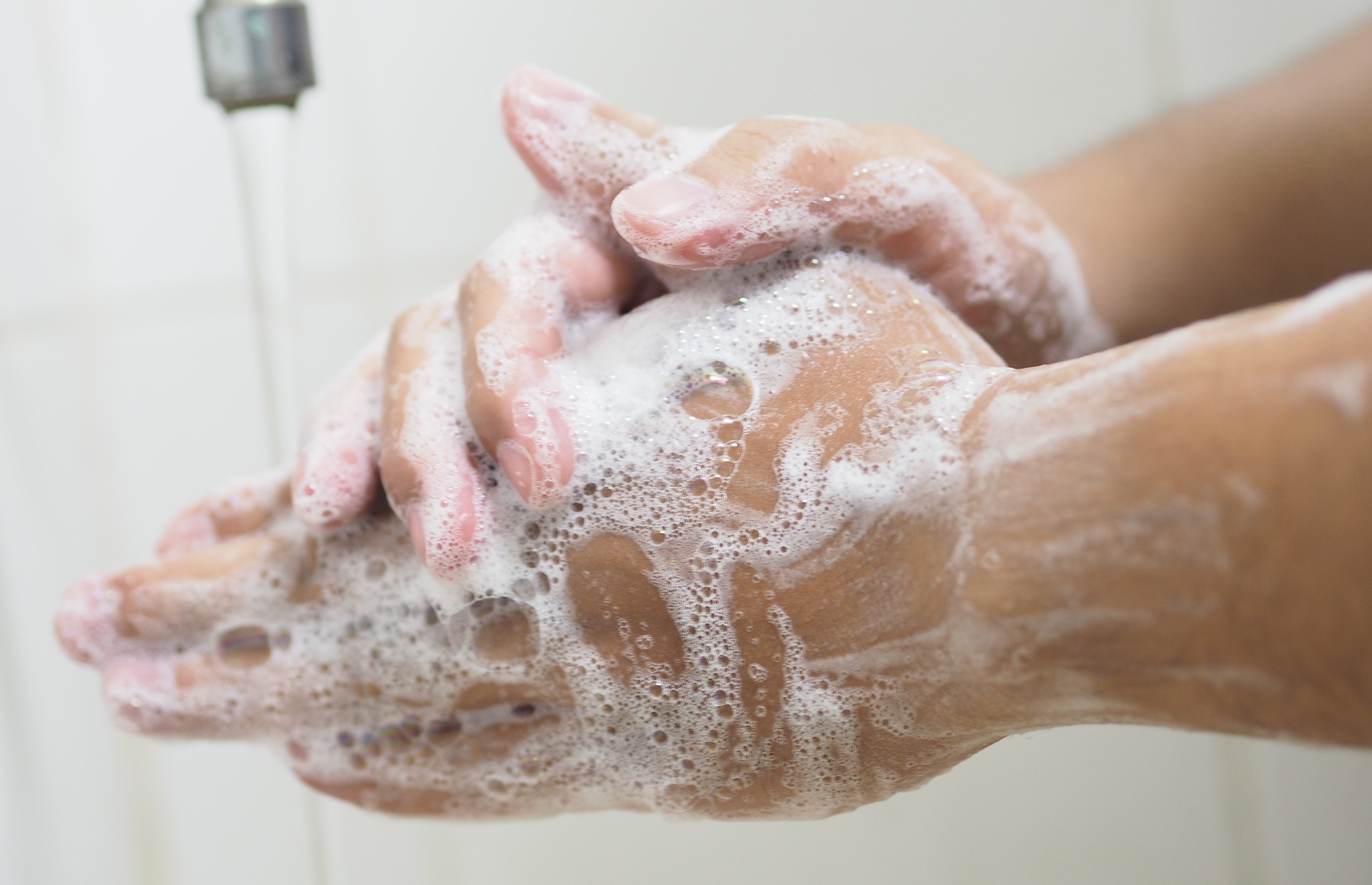 close up of hand washing with soap