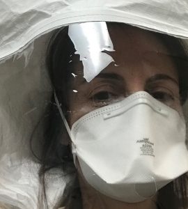 Physician assistant and Chapman professor Gabriela Belinsky during a fitting for the personal protective equipment she now uses when evaluating patients with potential COVID-19 symptoms at the medical clinic where she is helping out.