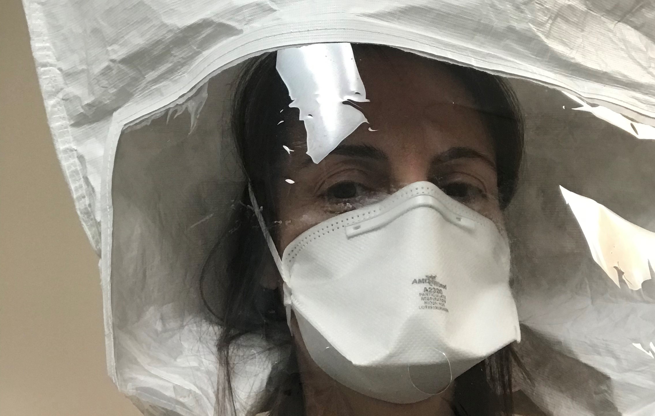 Physician assistant and Chapman professor Gabriela Belinsky during a fitting for the personal protective equipment she now uses when evaluating patients with potential COVID-19 symptoms at the medical clinic where she is helping out.