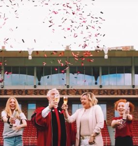 President struppa in robes with wife and daughters and confetti