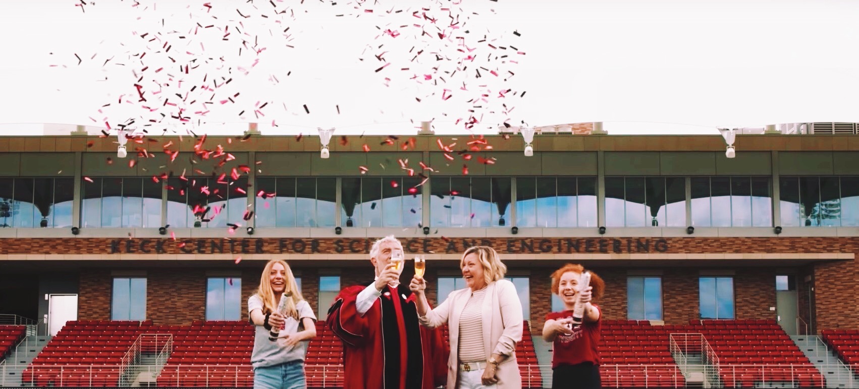 President struppa in robes with wife and daughters and confetti