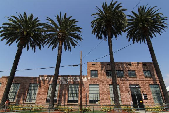 Exterior of brick building with palm trees