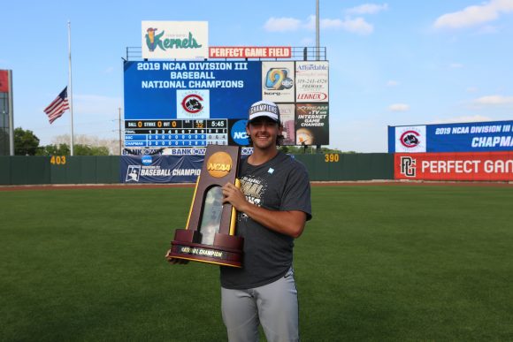 Baseball player holding trophy