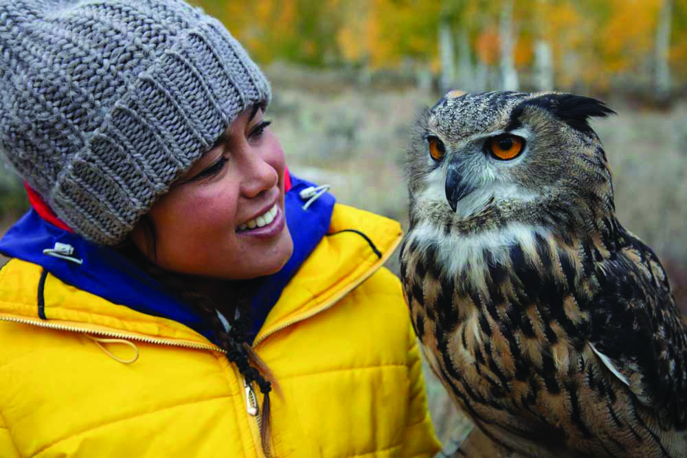 Ariel Tweto holds an owl. 