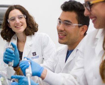 food science professor and two students in lab
