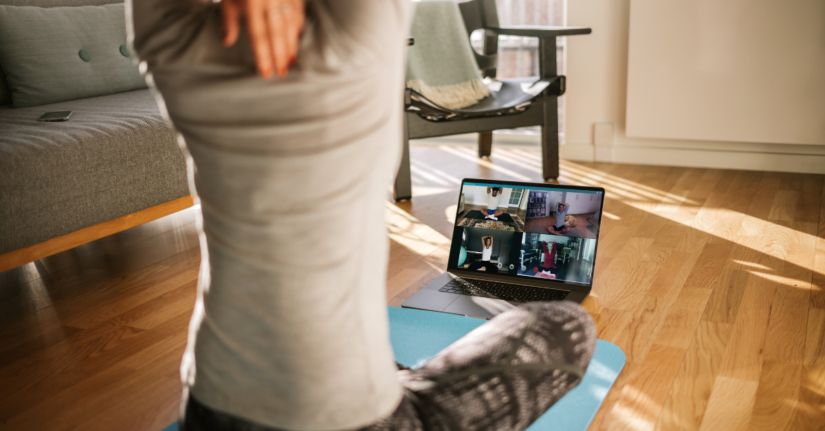 Fitness coach teaching yoga online to students