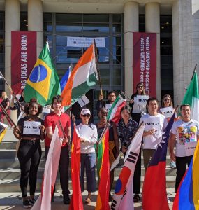 students holding flags of various countries.