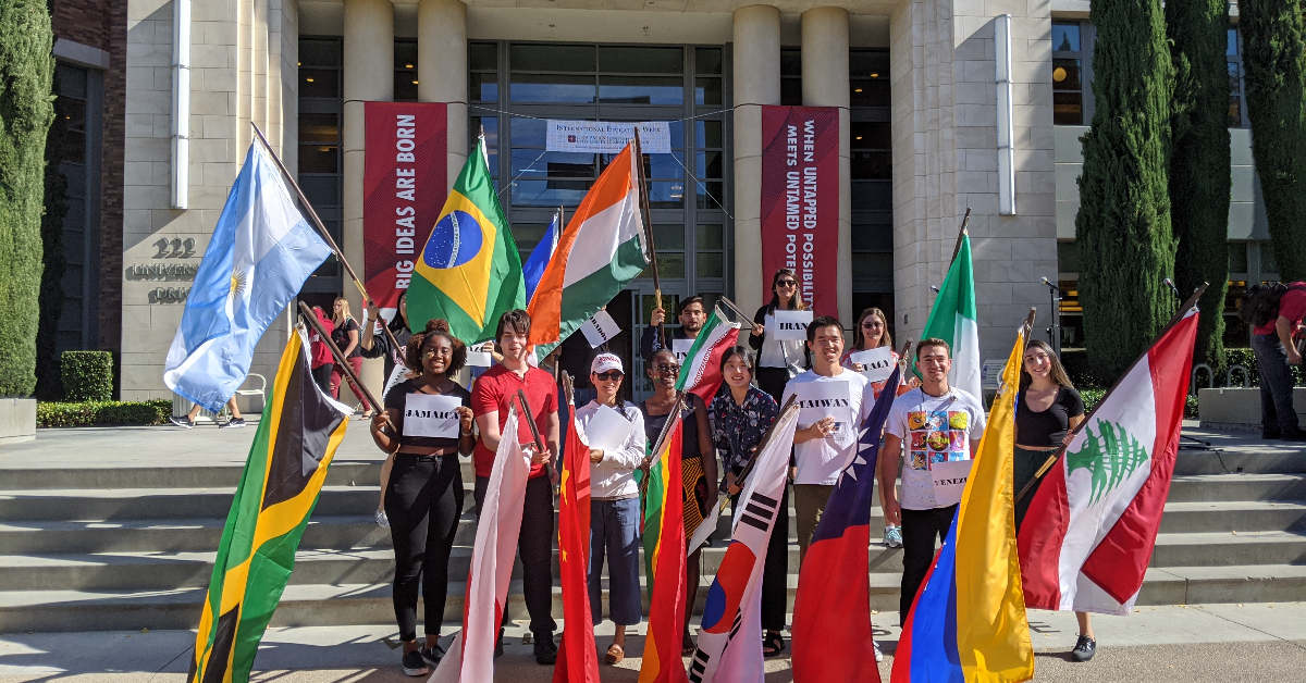students holding flags of various countries.
