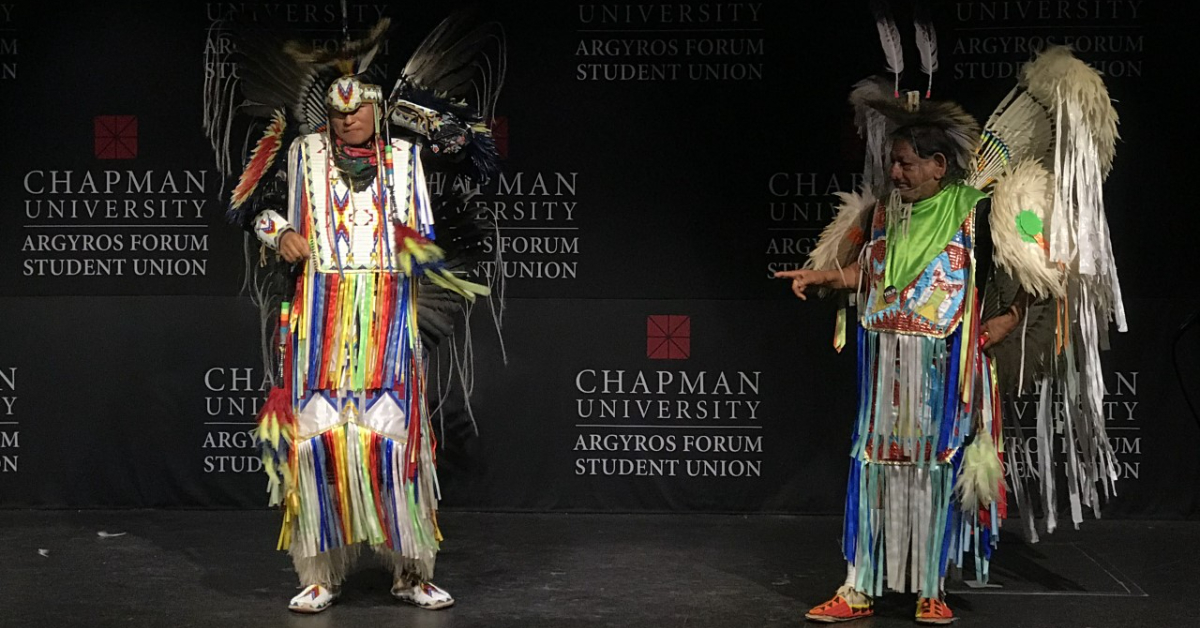 Two dancers in traditional native dress