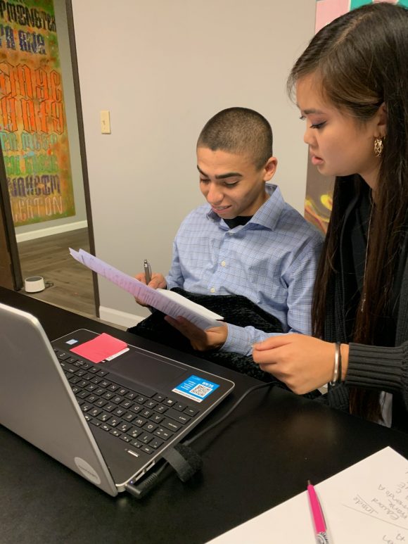 Sharon Tang assists a student with an assignment