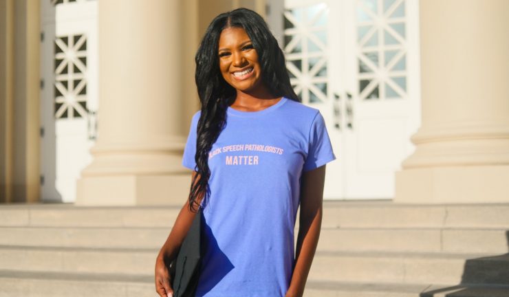 Alumna on the steps of Memorial Hall