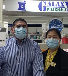 Pharmacists Karl and Amber Hess standing in pharmacy.