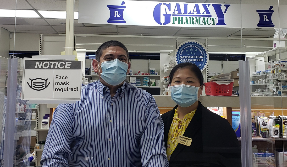 Pharmacists Karl and Amber Hess standing in pharmacy.