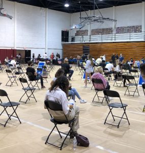 Students sit socially distanced at the Hutton Sports Center.