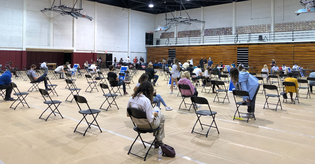 Students sit socially distanced at the Hutton Sports Center.