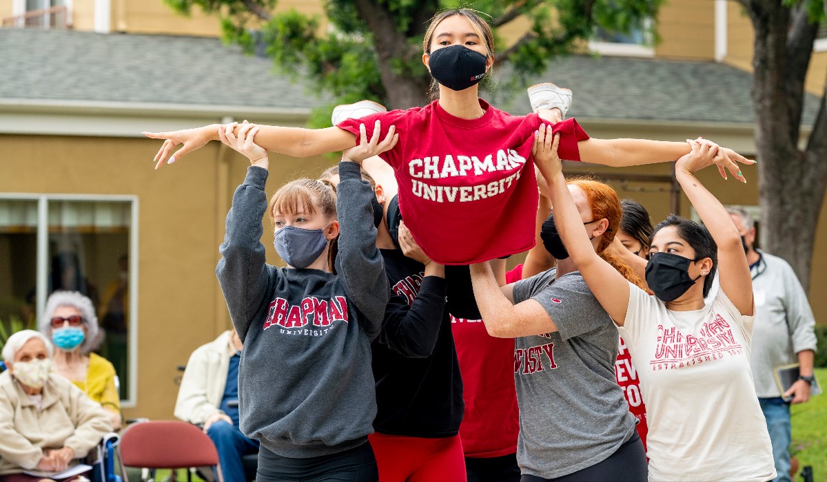 Dancer is lifted by fellow classmates at dance performance.