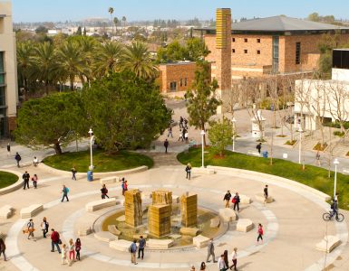 Panoramic view of people walking across Attallah Piazza.