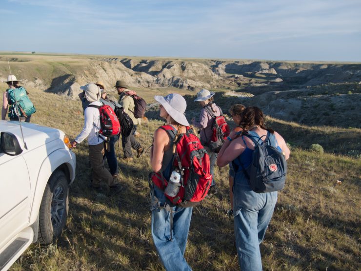 Chapman students along with a paleontology team from Oklahoma State University prepare to descend into the rocky terrain of a Montana coulee in search of fossilized dinosaur bones. (Photo courtesy of Ben Tuschman)