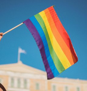 Person waving rainbow flag.